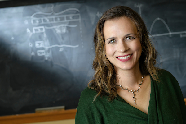 location portrait of a person standing in front of a chalkboard