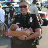 police officer holding baby