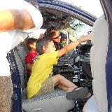 kid sitting in front seat of police cruiser