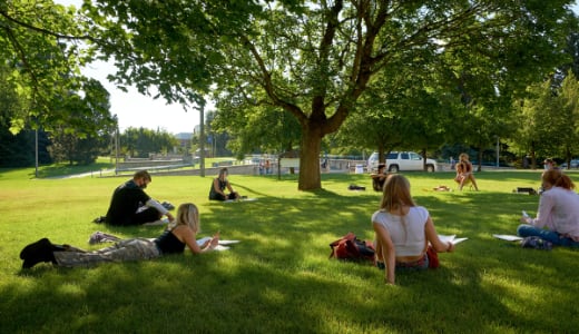 A college class meets on the grass in a socially distanced circle at Montana State University.