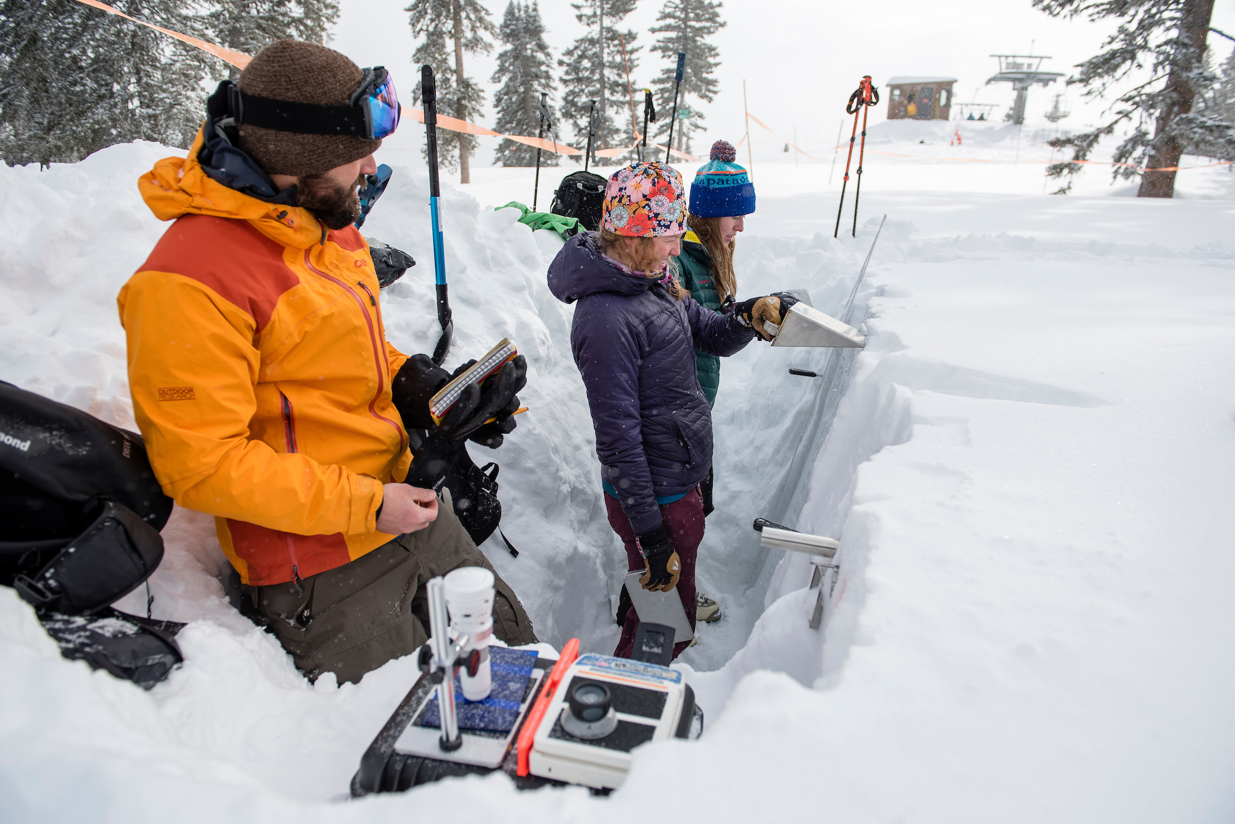 Students in snow pit conducting research