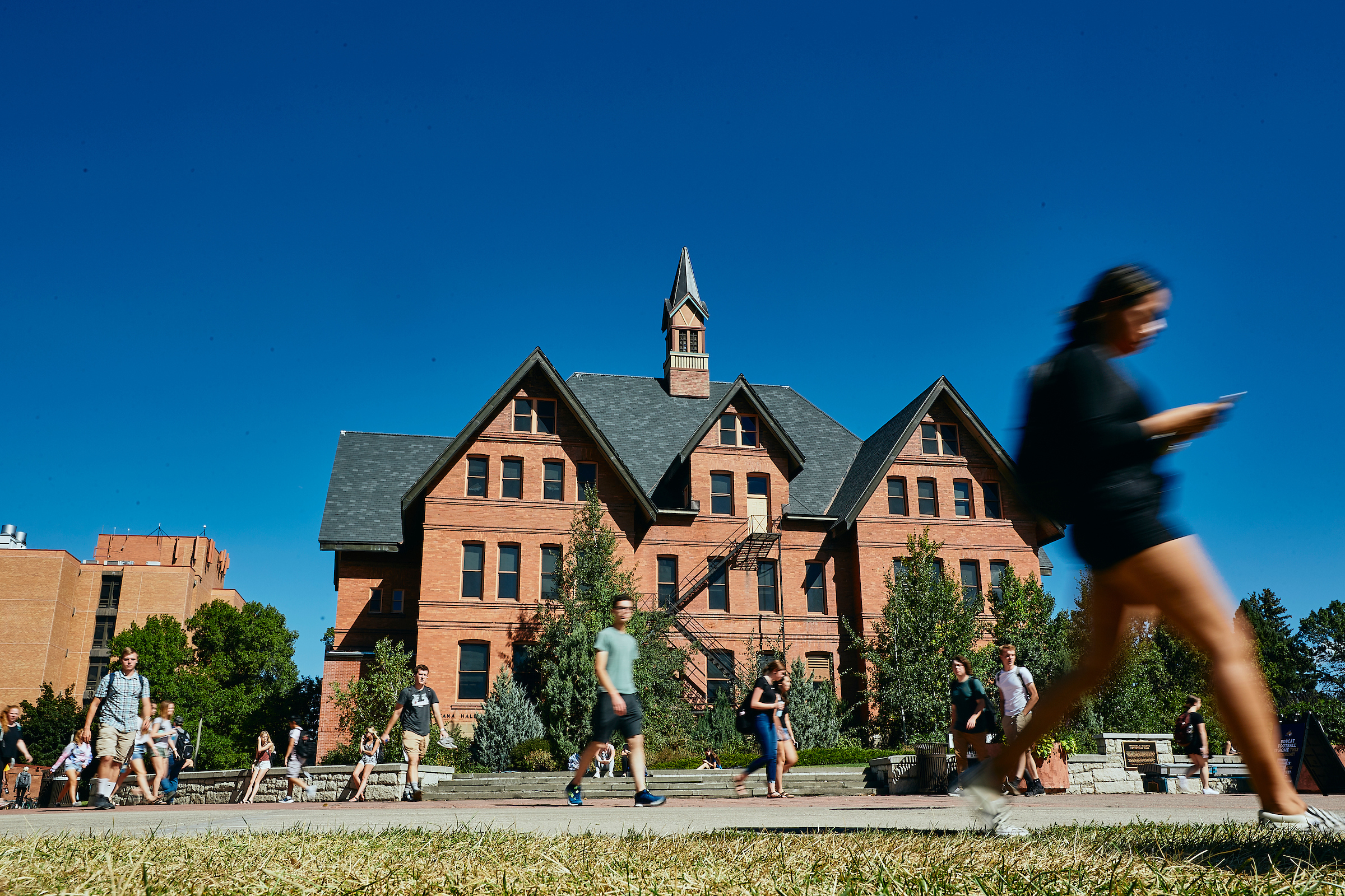 students on Mall walking past Montana Hall