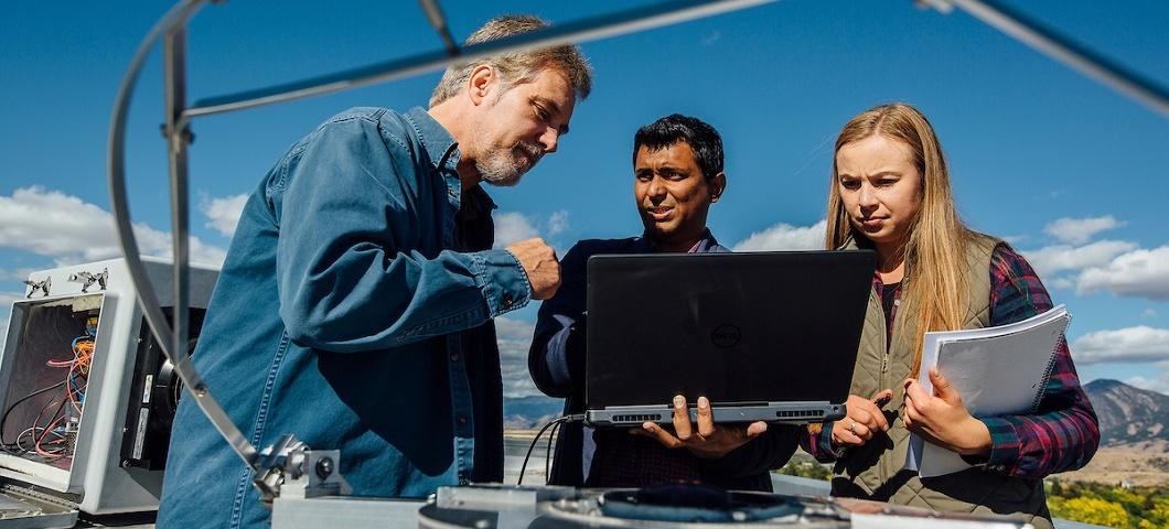 Three people with laptop