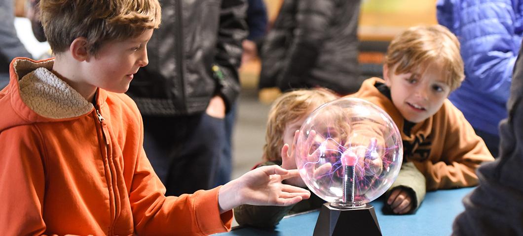 Children explore a plasma ball display ahead of "Mr. G’s" Science of Light and Sound Show on April 16, part of World Quantum Day celebrations.