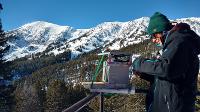 Graduate student, Diana Saly prepares a time-lapse camera to track backcountry usage, Bridger Range, MT