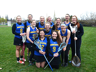 Women's Lacross Club team pose for a photo in their uniforms