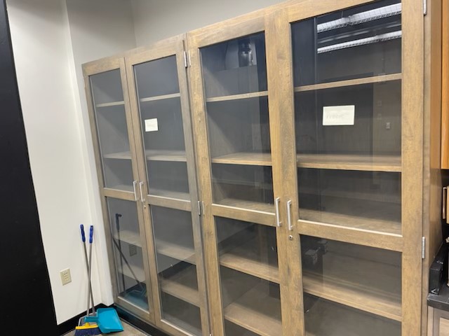  2 large cabinets with glass doors