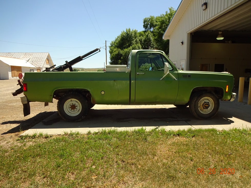 Green pickup with soil probe in the bed