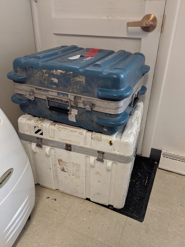 Two hard shell cases, larger white and smaller blue