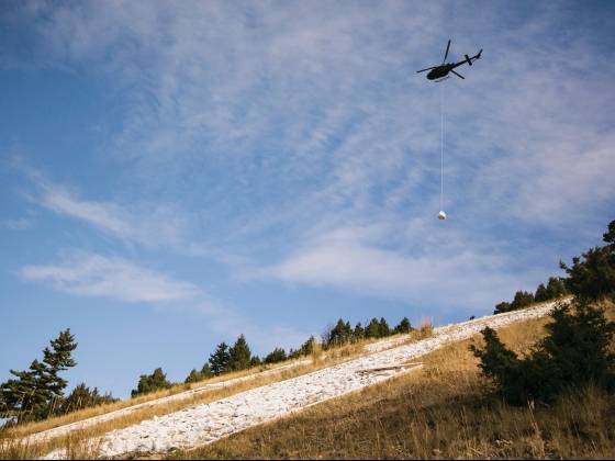 A helicopter airlifted four pallets of rocks to the M.