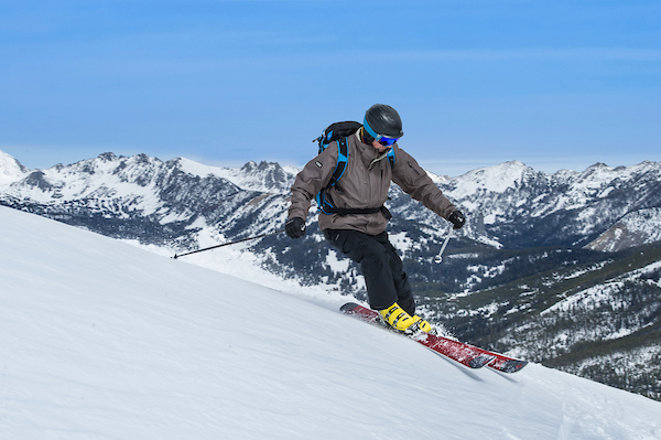 Image of a downhill skiier on the side of a mountain.