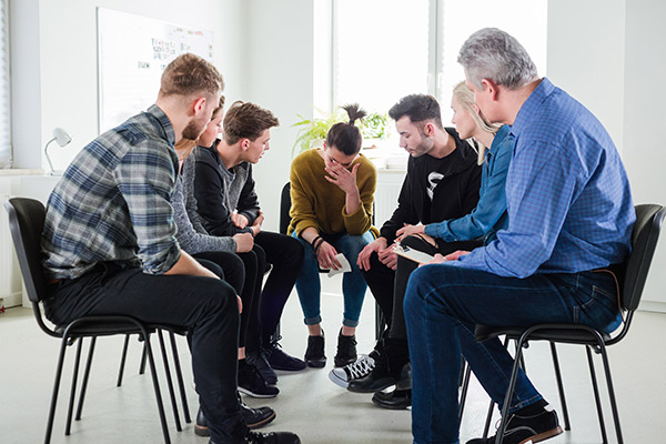 Group counseling session with participats sitting in a circle