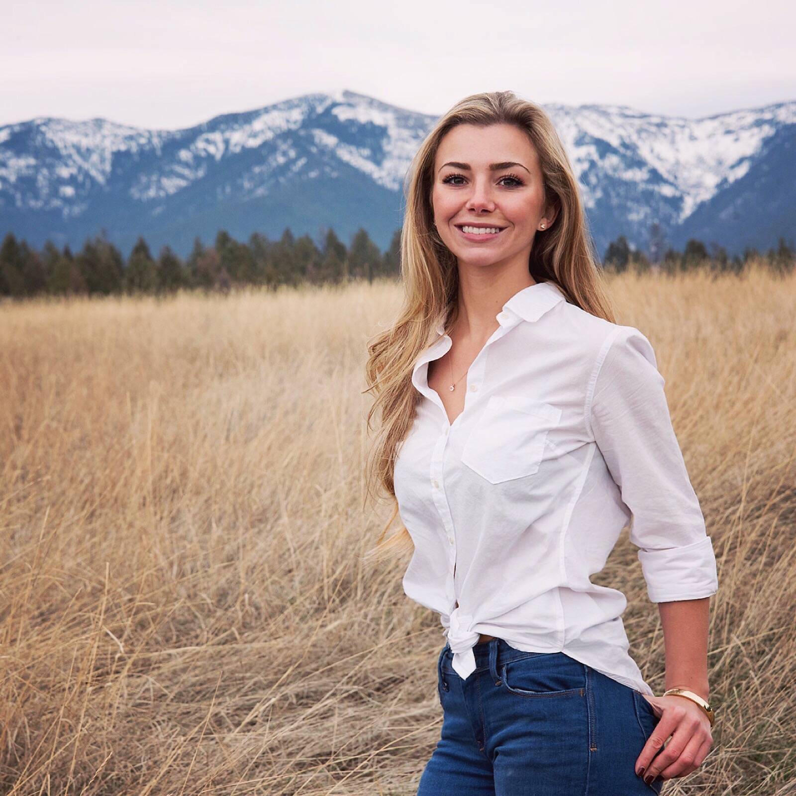 Gussie in front of some Montana mountains